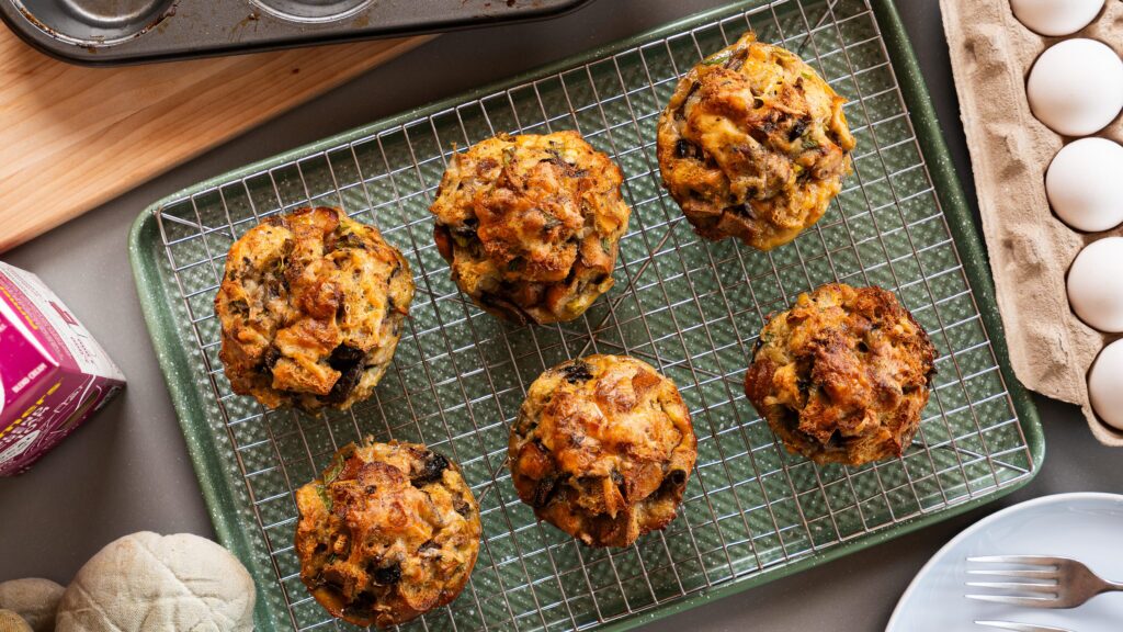 Savoury breakfast egg muffins sitting on a wire rack-just out of the oven.