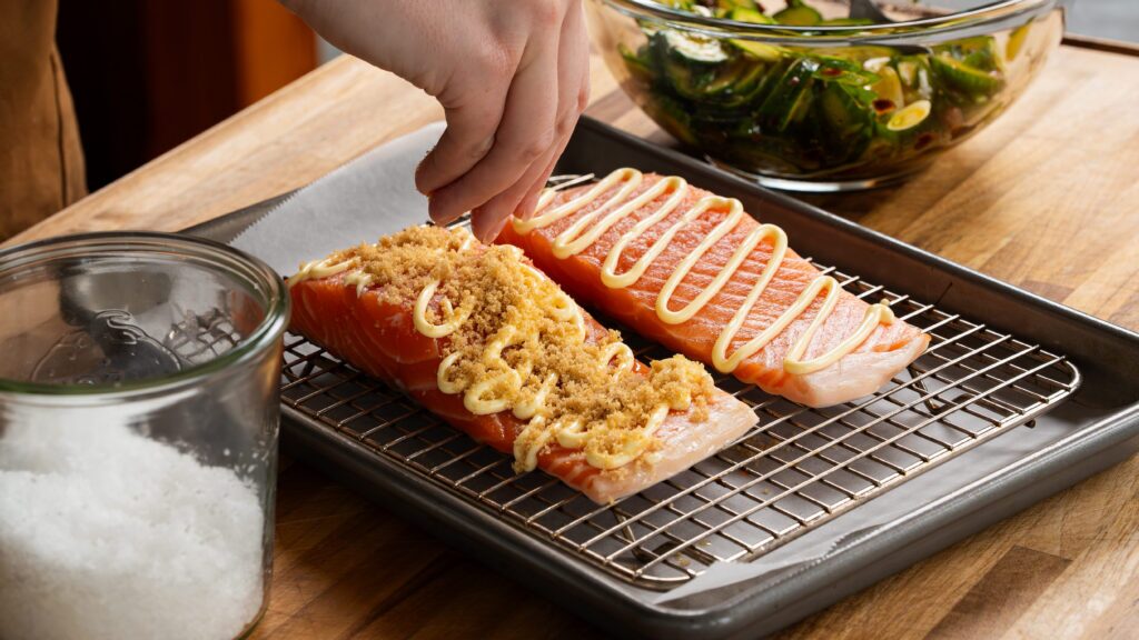 Adding brown sugar on top of salmon to make a delicious brown sugar salmon dish.