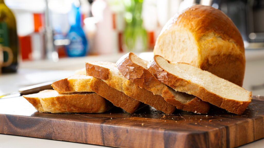 Sliced cottage cheese bread on a cutting board.