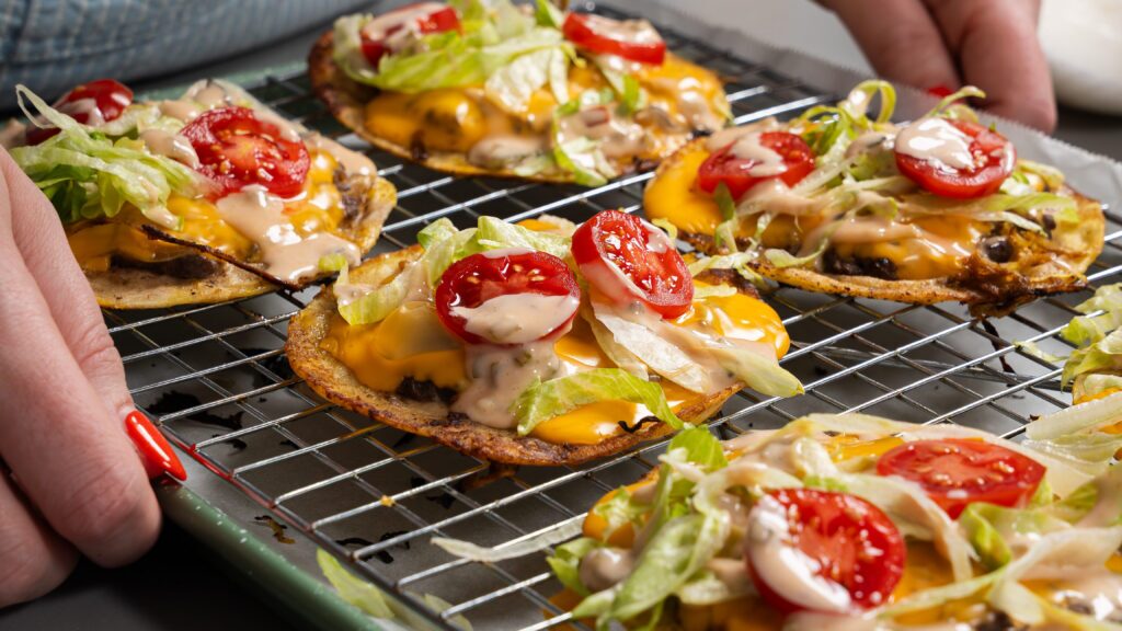 Oklahoma onion burger tacos on a cooking rack.