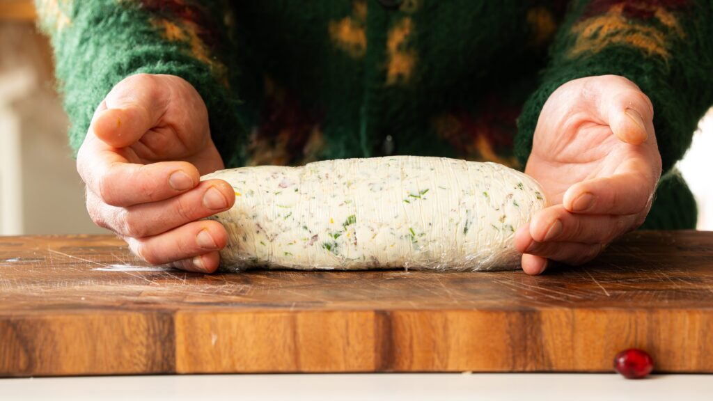 Wrapping this cheese ball recipe in plastic wrap to help hold its form.