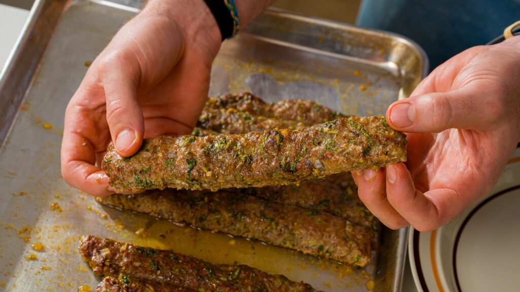 Seasoned and cooked chicken kebabs just out of the oven.