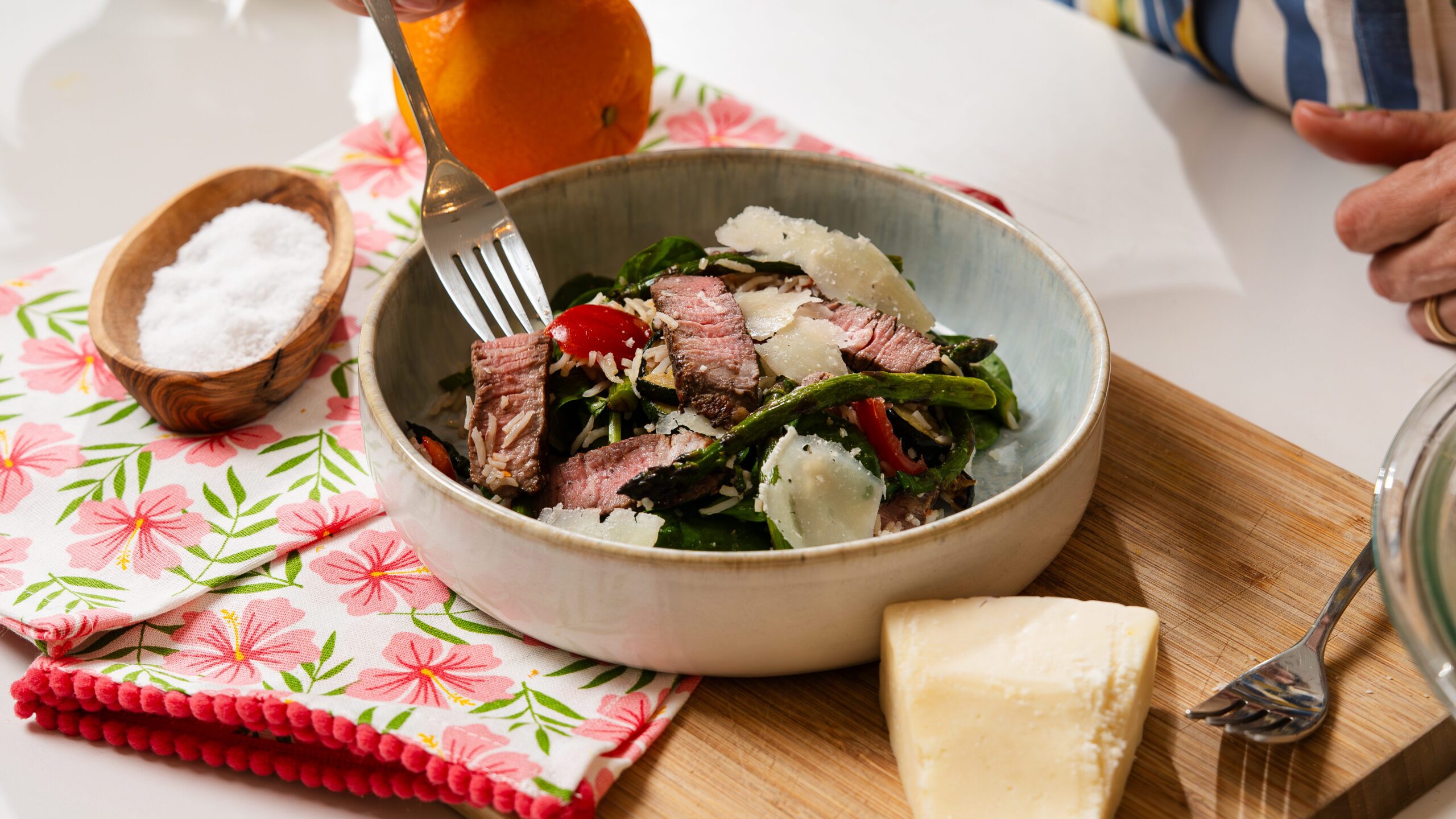 Steak salad recipe with grilled veggies and rice in a white bowl.