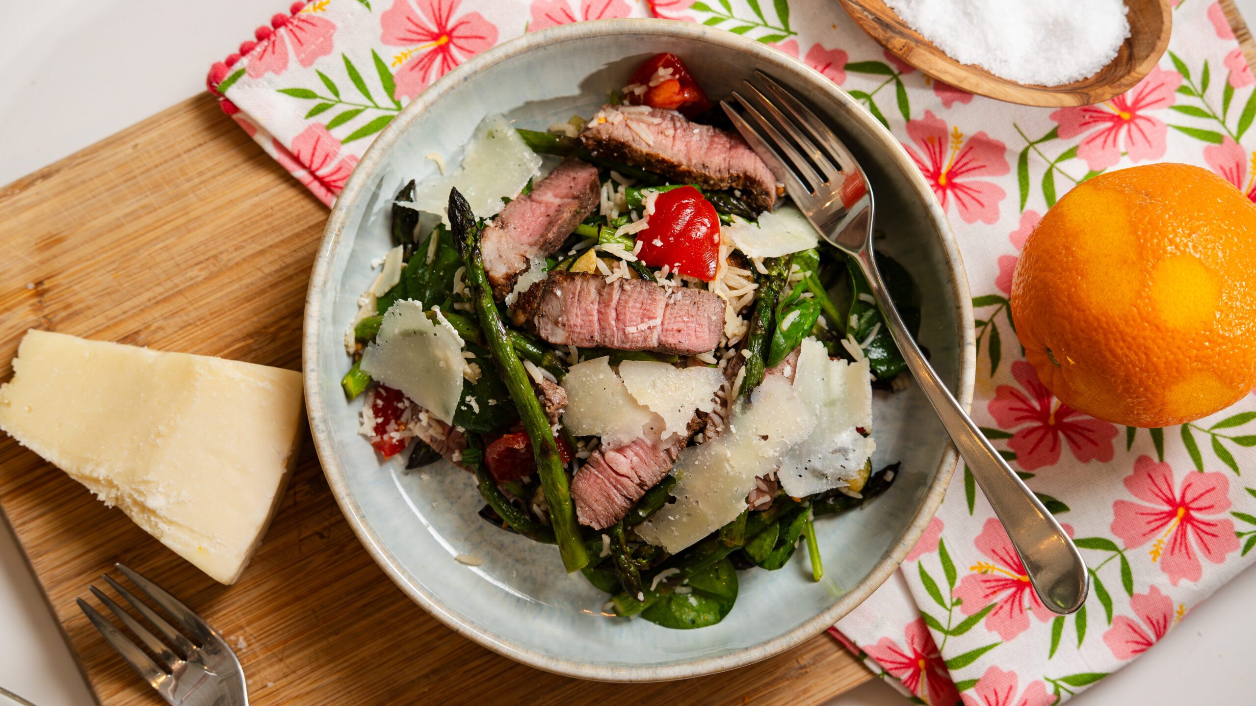 Steak salad recipe with grilled veggies and rice in a white bowl.