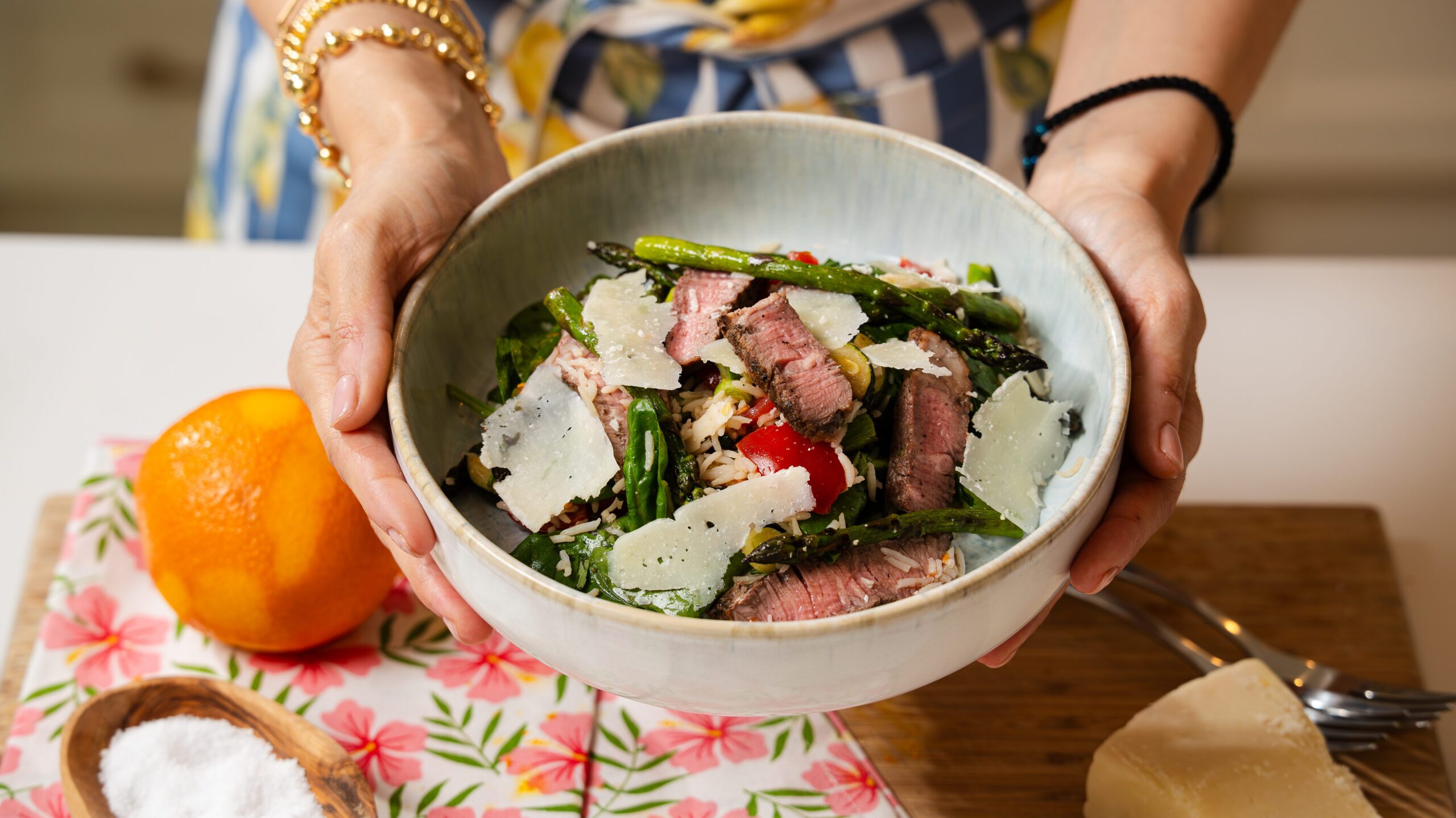 Steak salad recipe with grilled veggies and rice in a white bowl.
