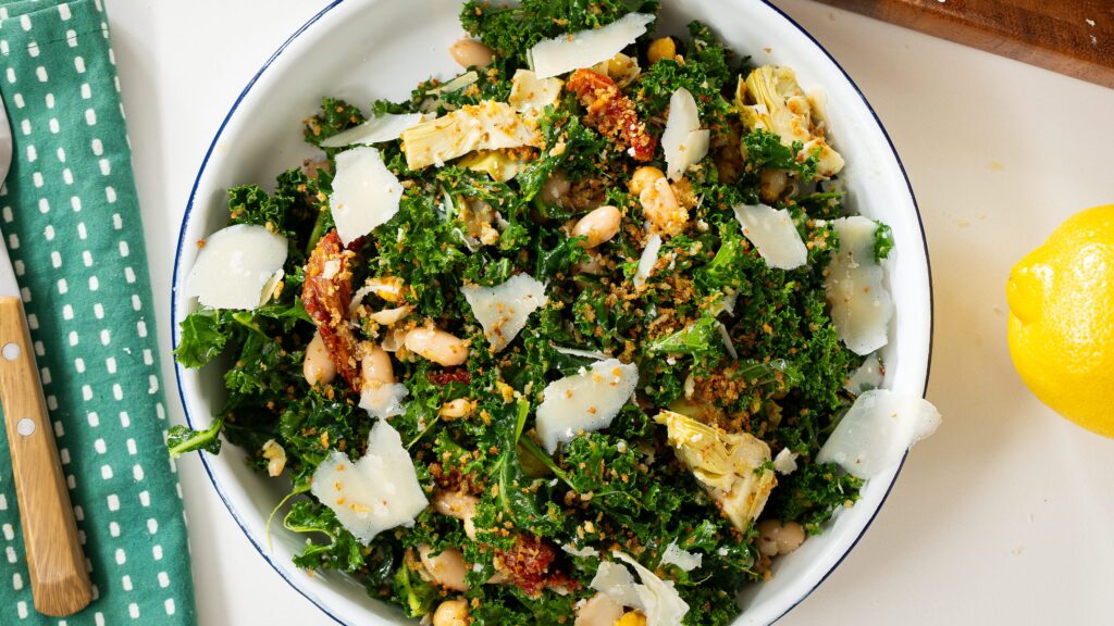 White bean salad with kale and warm in a bowl.