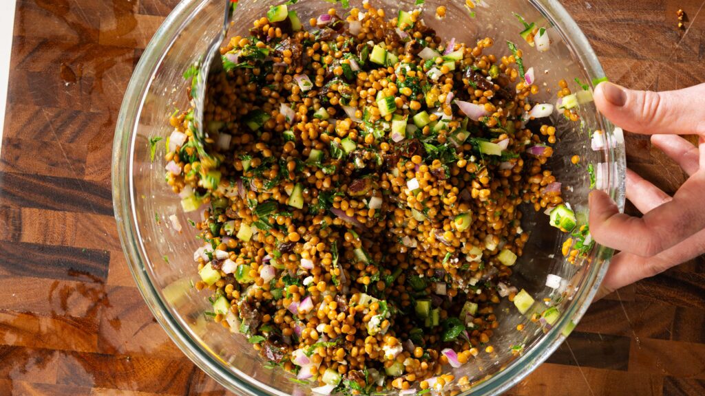 Lentil salad recipe in a large mixing bowl.