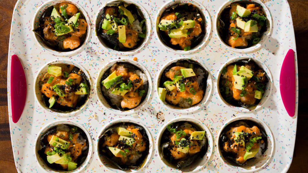Spicy salmon rice muffins in a muffin tin.