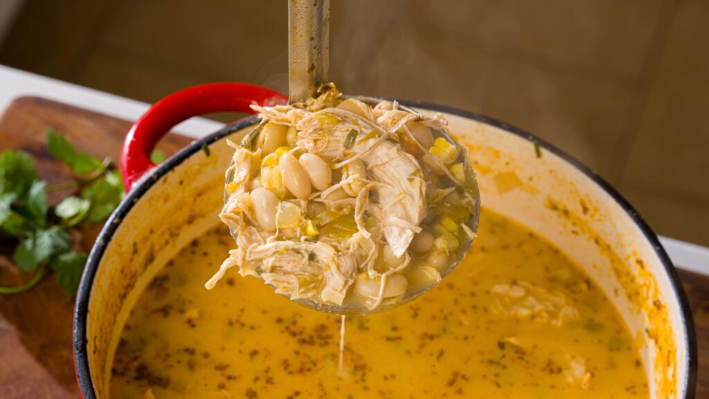 Ladling a delicious white bean chicken chili.