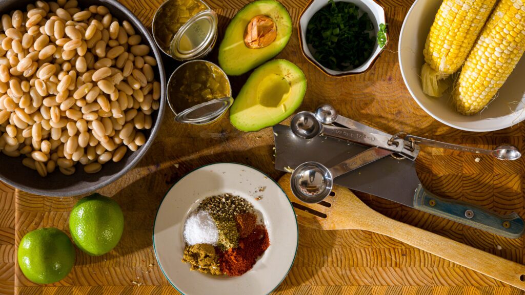 White bean chicken chili ingredients on a cutting board.
