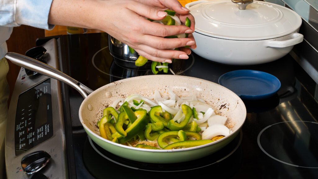 Sautéing veggies for a delicious cheesesteak sandwich.
