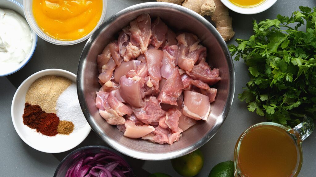 Overhead ingredient shot for a mango chicken recipe.