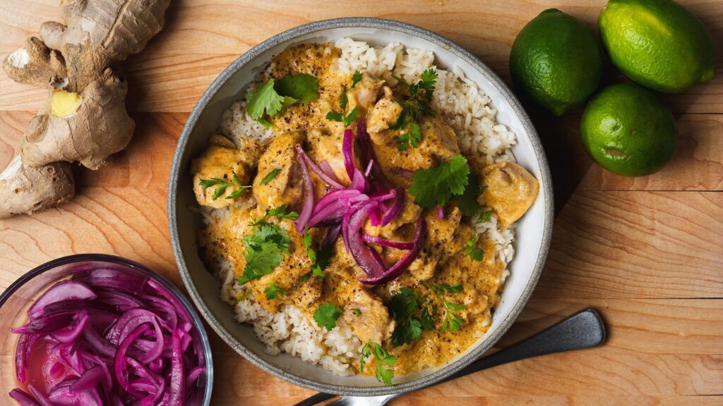 Mango chicken in a bowl with rice.