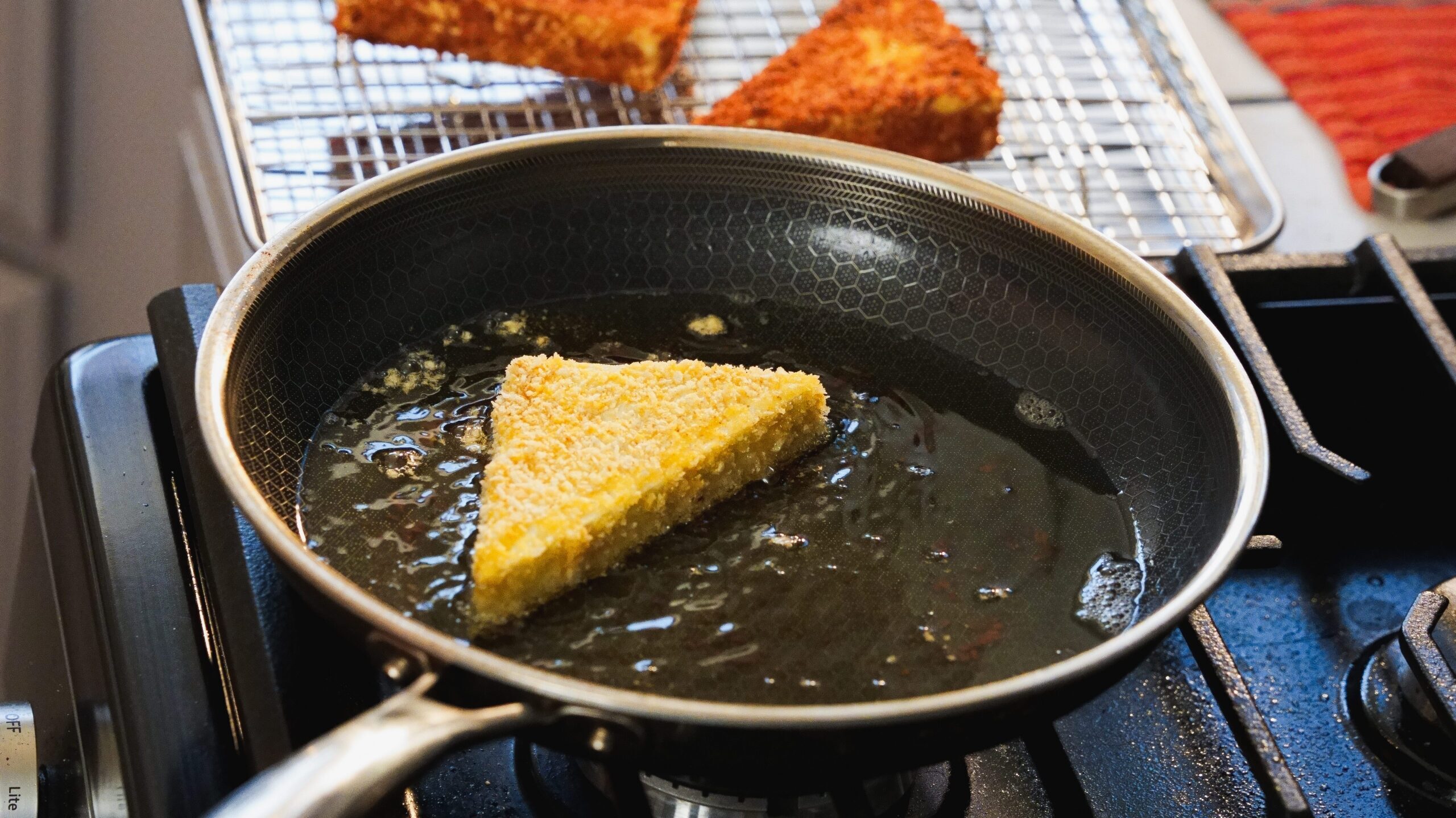 Frying the tofu in a frying pan.
