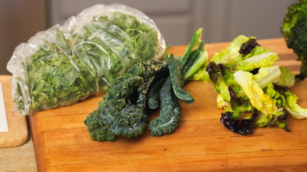 A collection of lettuces on a cutting board for freezing later on. Shredded lettuce for freezing wont' yield the best results.