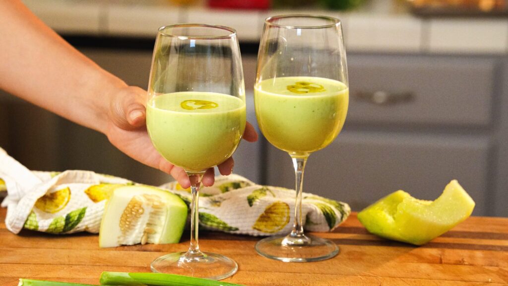Cucumber gazpacho in two wine glasses for serving.