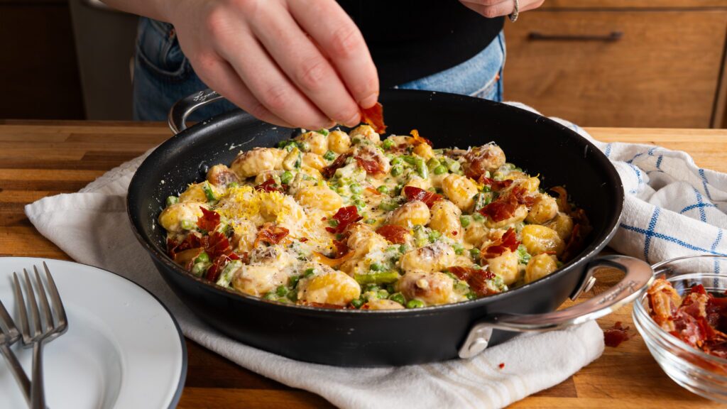 Adding prosciutto to a an easy gnocchi skillet.