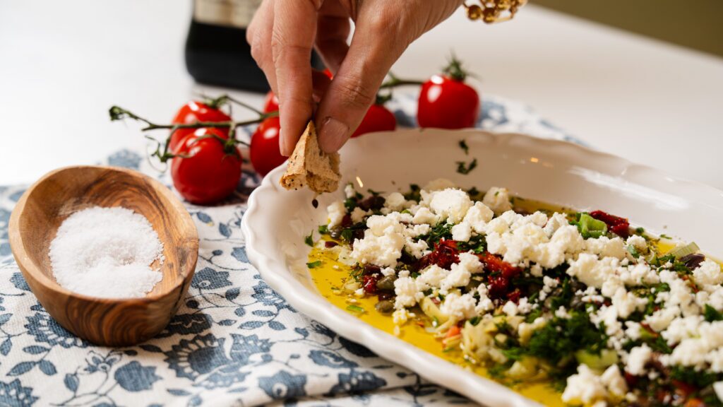 Taking a scoop of this olive oil bread dip.