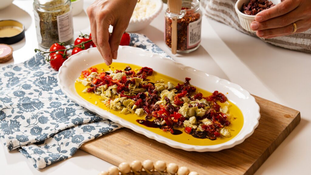 Adding ingredients to this olive oil bread dip.