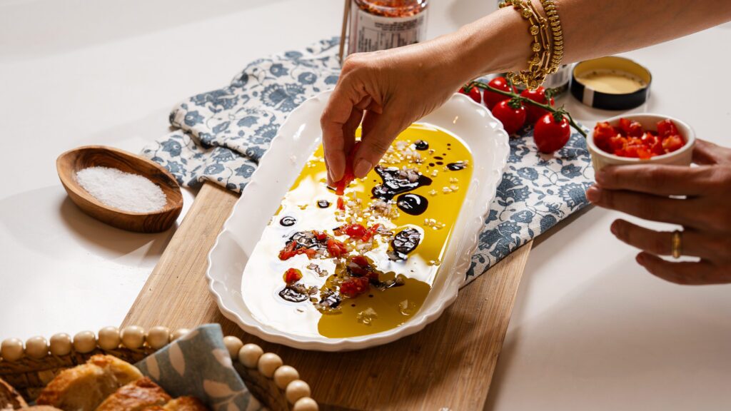 Adding fresh tomato to this olive oil bread dip.