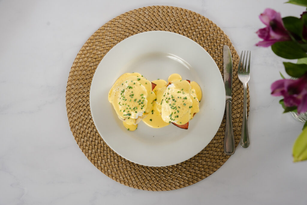 A classic eggs benny covered in hollandaise