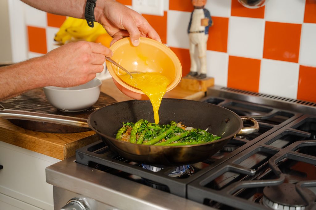 Pouring eggs into the pan