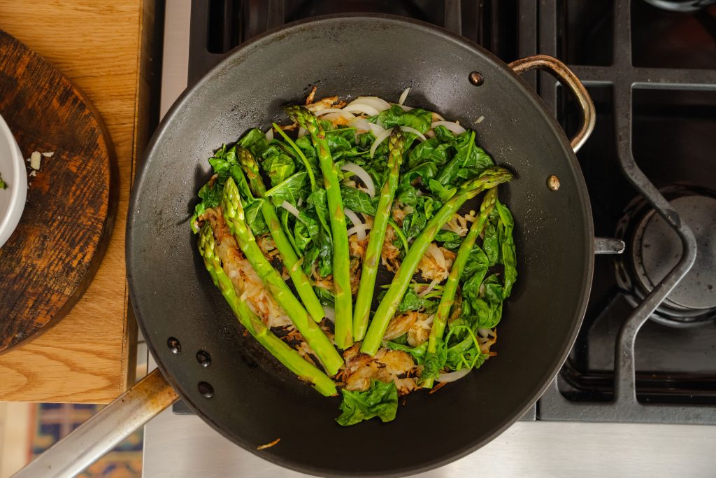 Asparagus, potatoes and onion in a pan