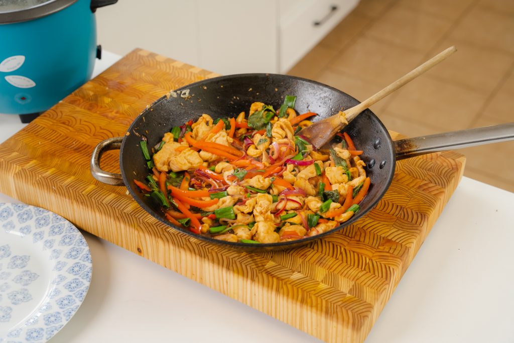 A large frying pan full of Cashew Chicken.