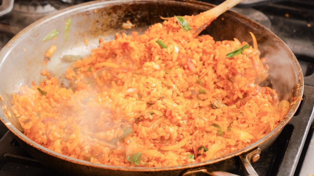 Kimchi Fried Rice in being cooked and tossed in a pan!