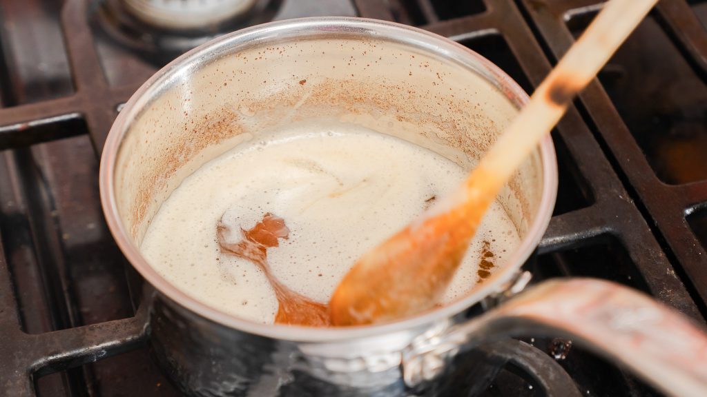 A close up shot of butter being browned in a small pot. 