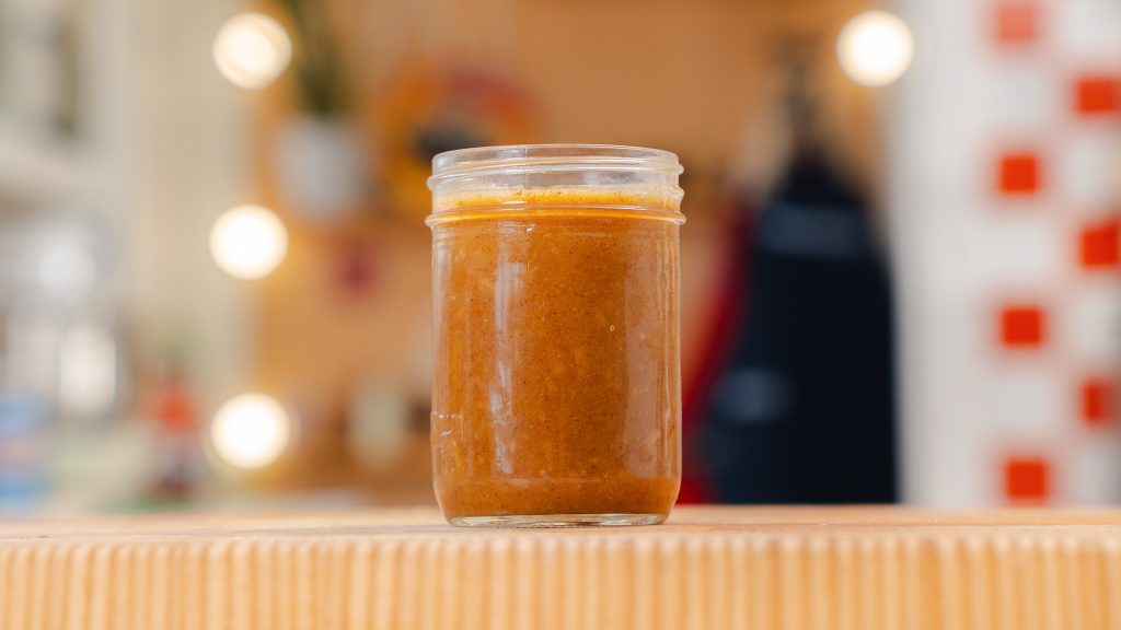 a close up of Brown Butter Vinaigrette in a small clear mason jar.