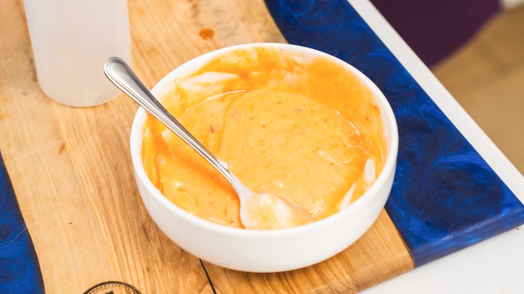 A close up shot of the Bang Bang Chicken sauce in a white bowl. 