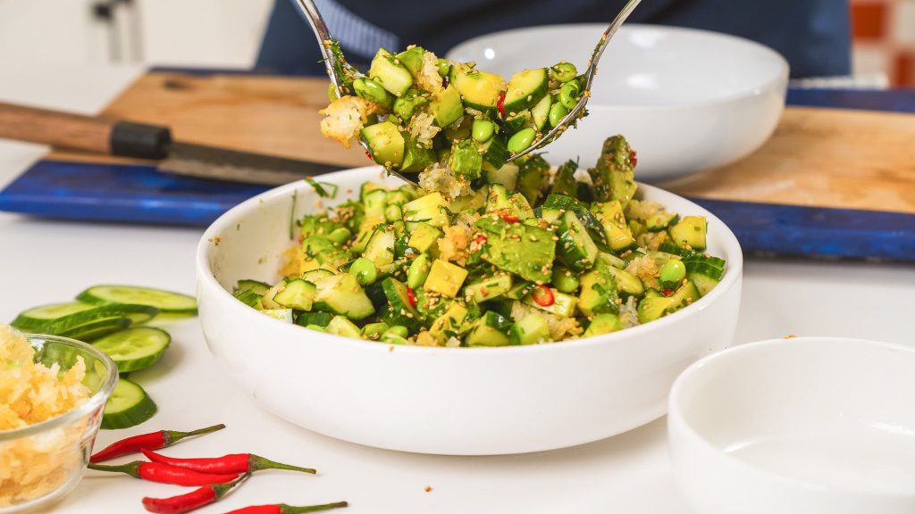 spoons digging into crispy rice salad