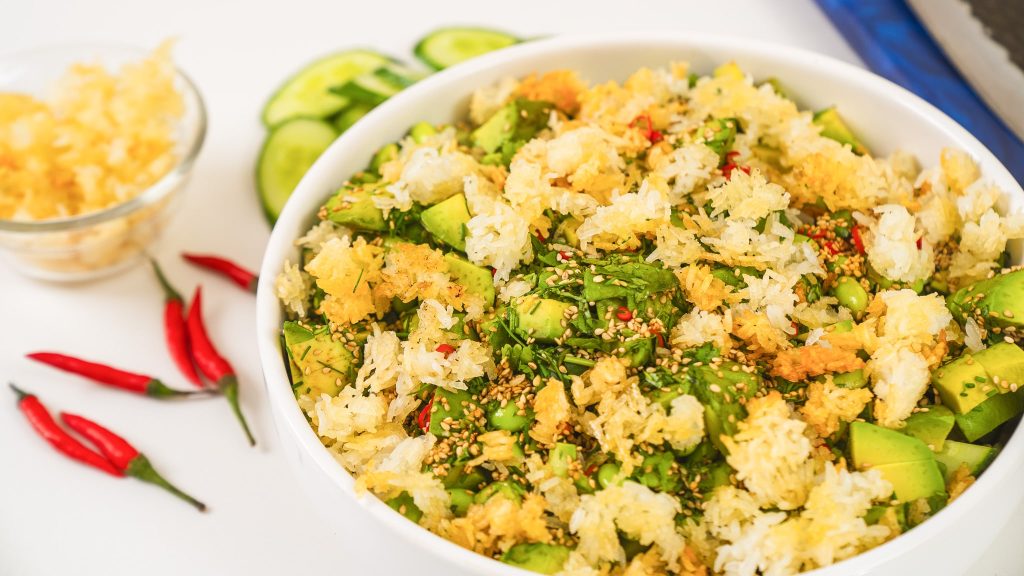 large bowl of salad topped with crispy rice