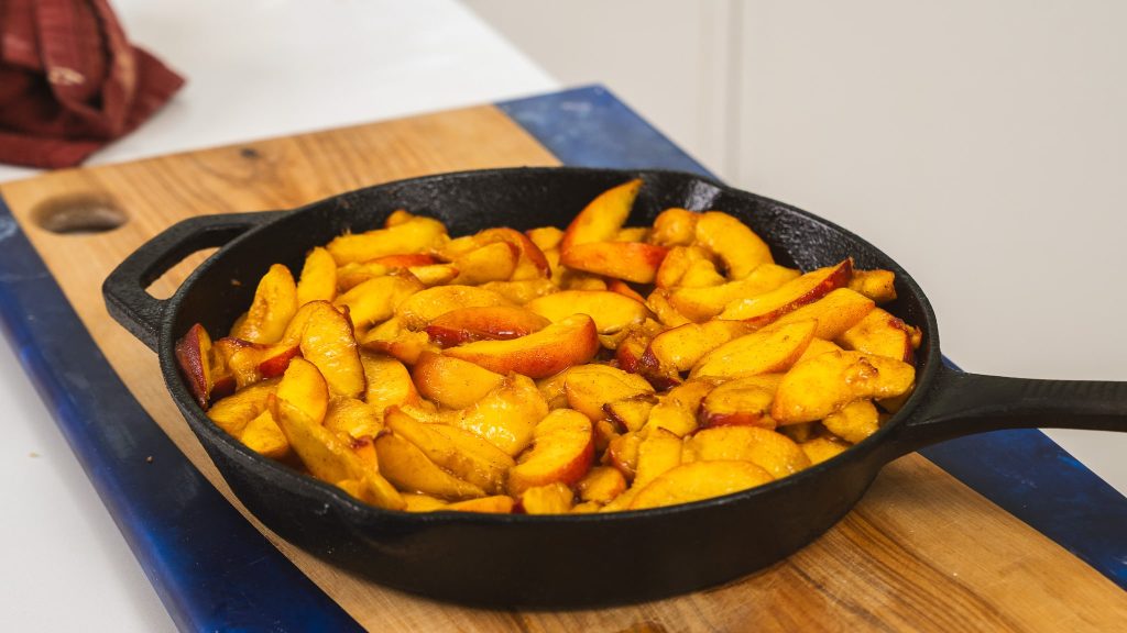 sliced peaches in cast iron skillet