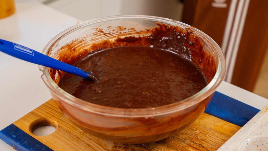 large glass bowl of chocolate cupcake batter