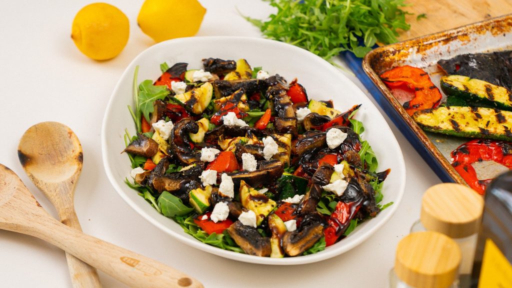 charred veggie salad surrounded by ingredients