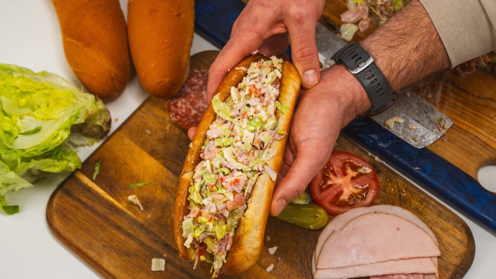 Chopped Italian sandwich with deli meat and cheese, stuffed into a bun.