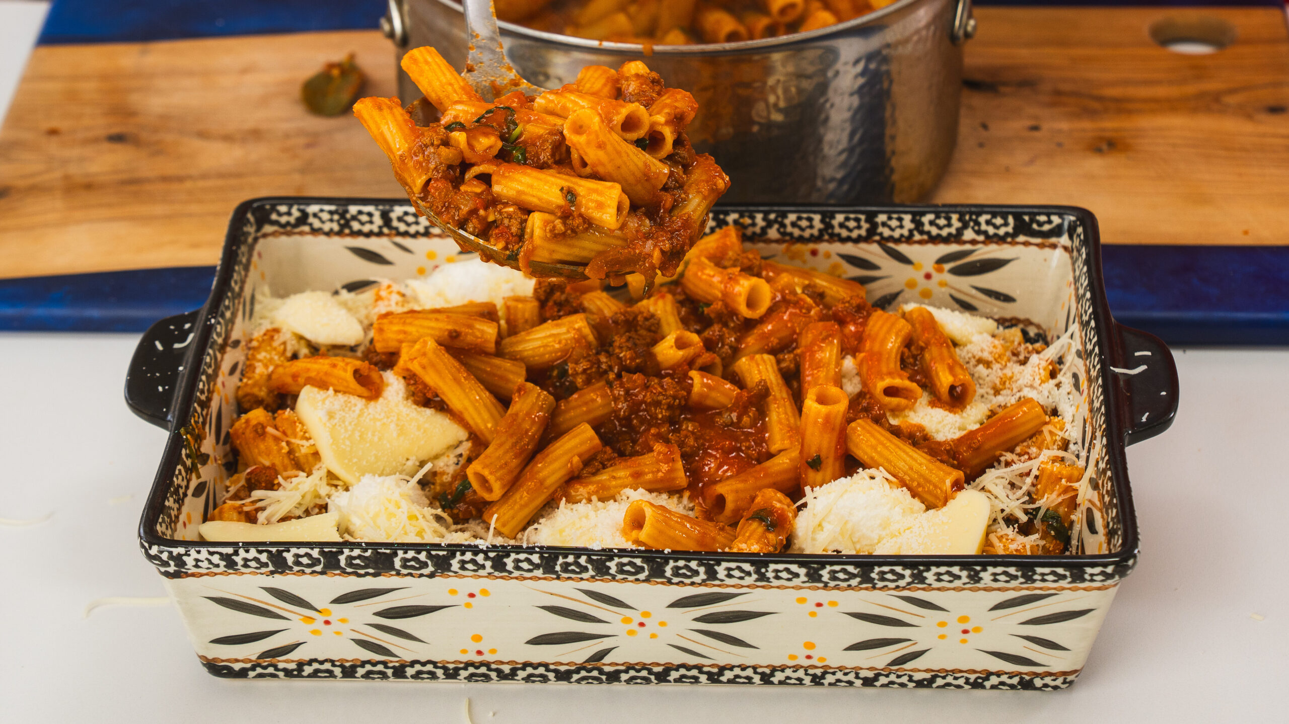 Baked rigatoni in a large casserole dish with mozzarella cheese on top