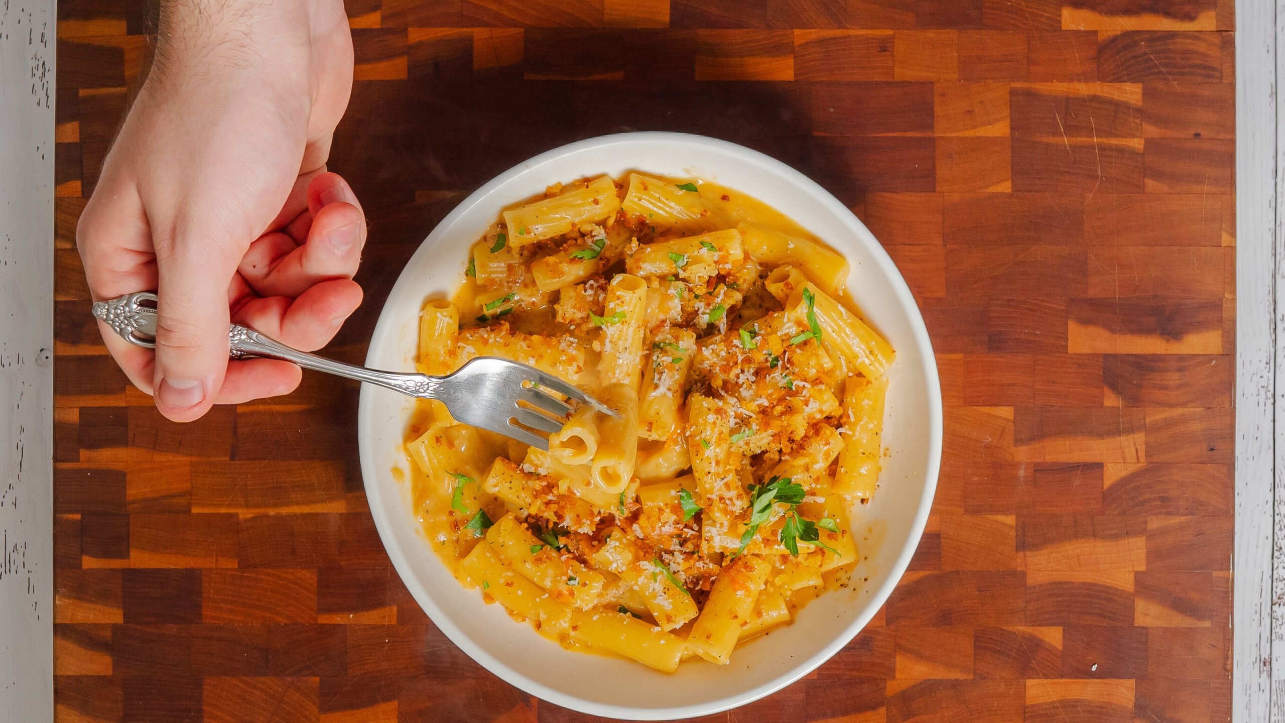 A white bowl filled with cherry tomato pasta