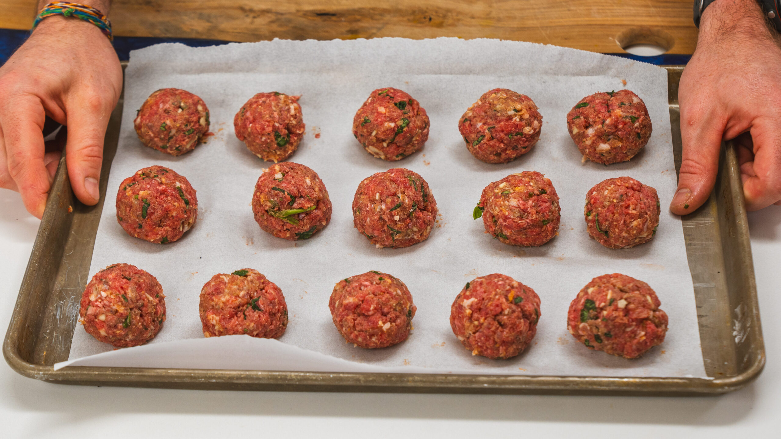 homemade meatball recipe on a parchment-lined cookie sheet.