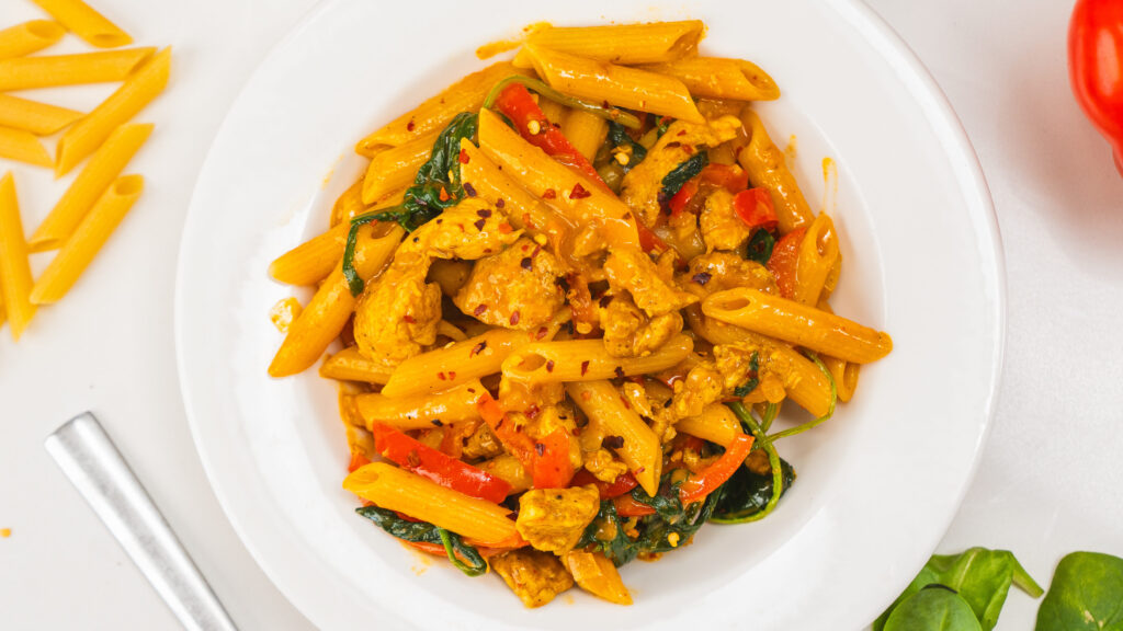 Maple Curry Chicken Pasta in a white bowl.