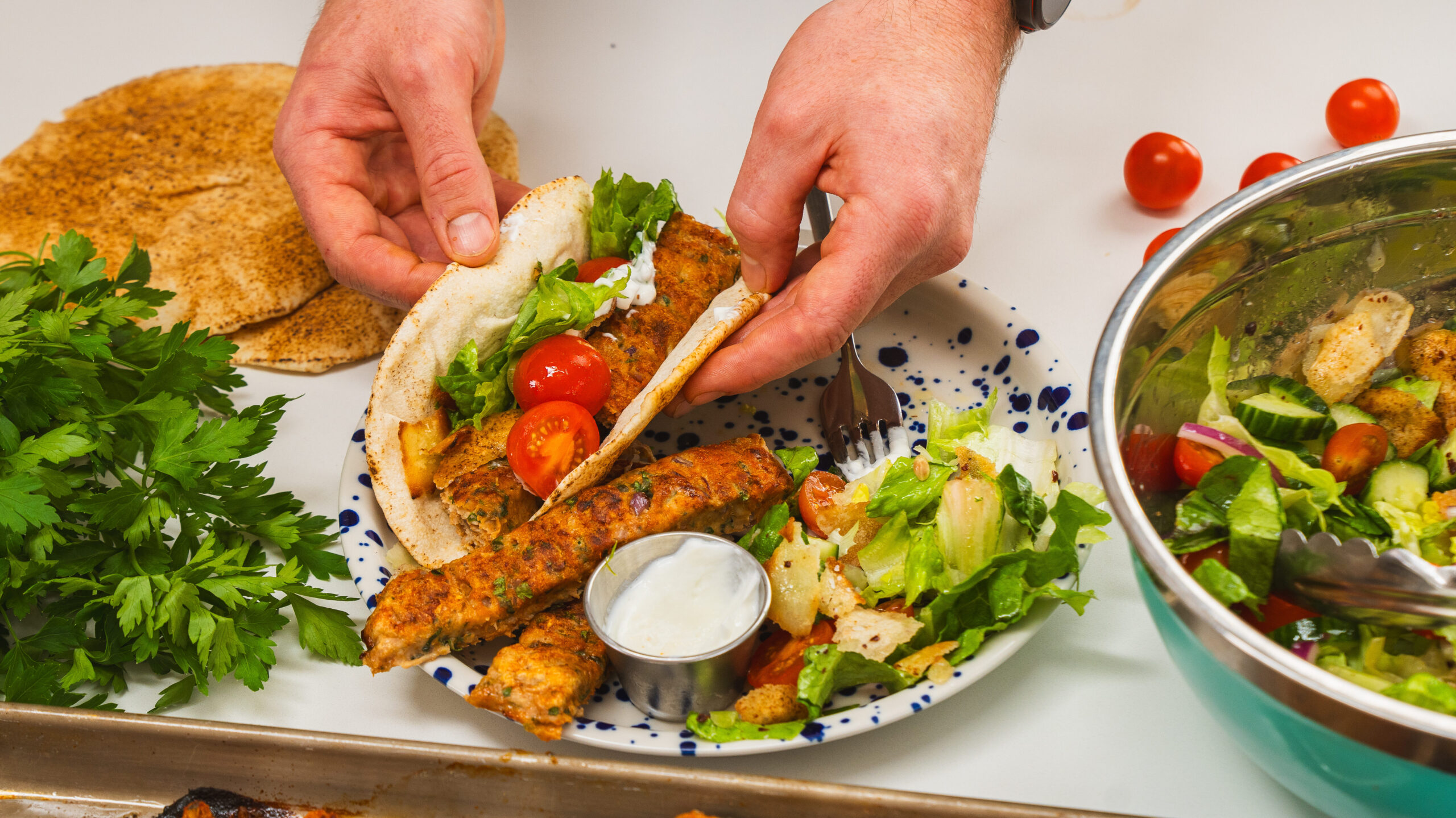 A plate of easy chicken kofta, salad and pita bread.