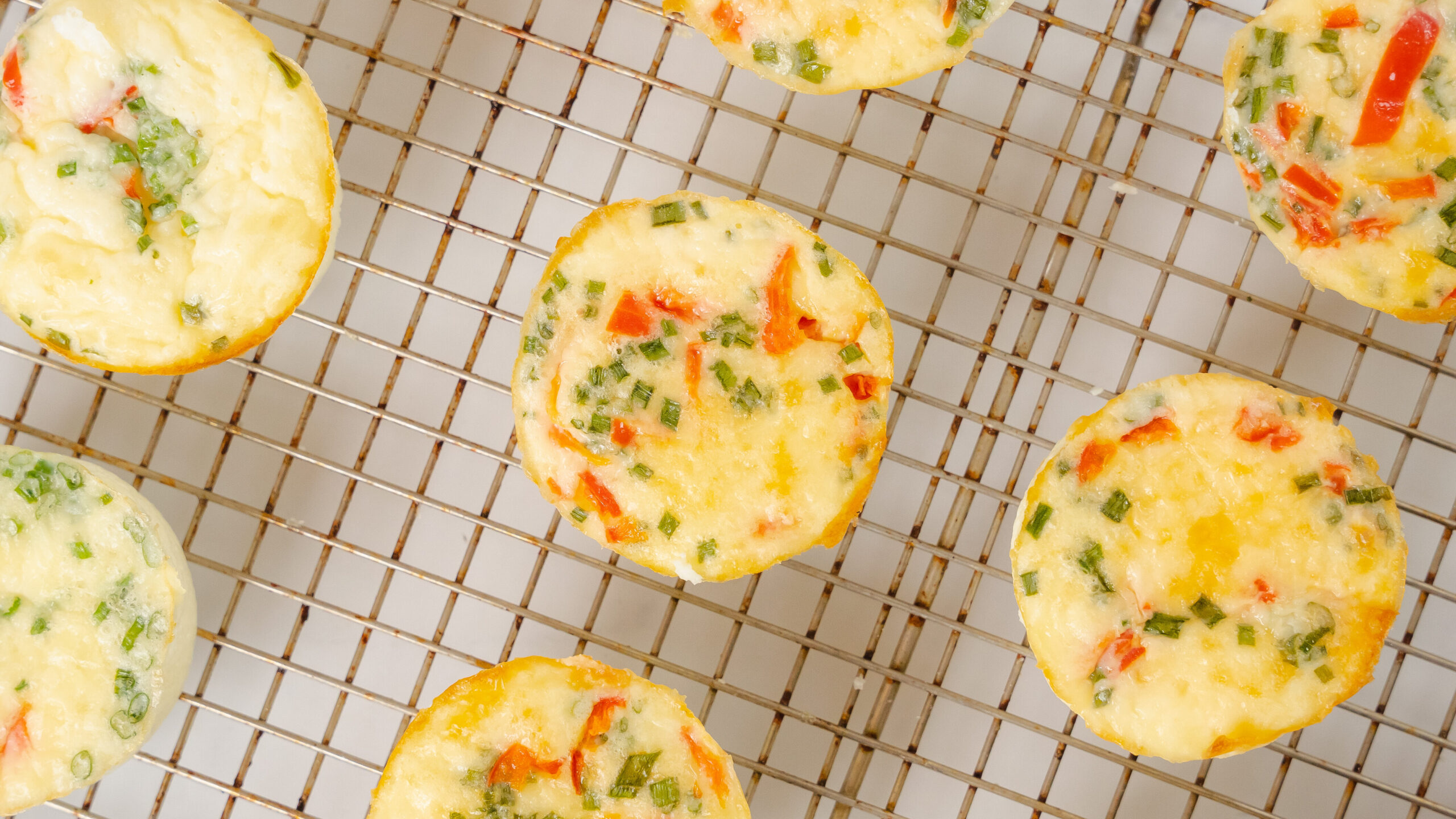 Starbucks egg butes recipe with egg bites sitting on a a cooling wire rack.