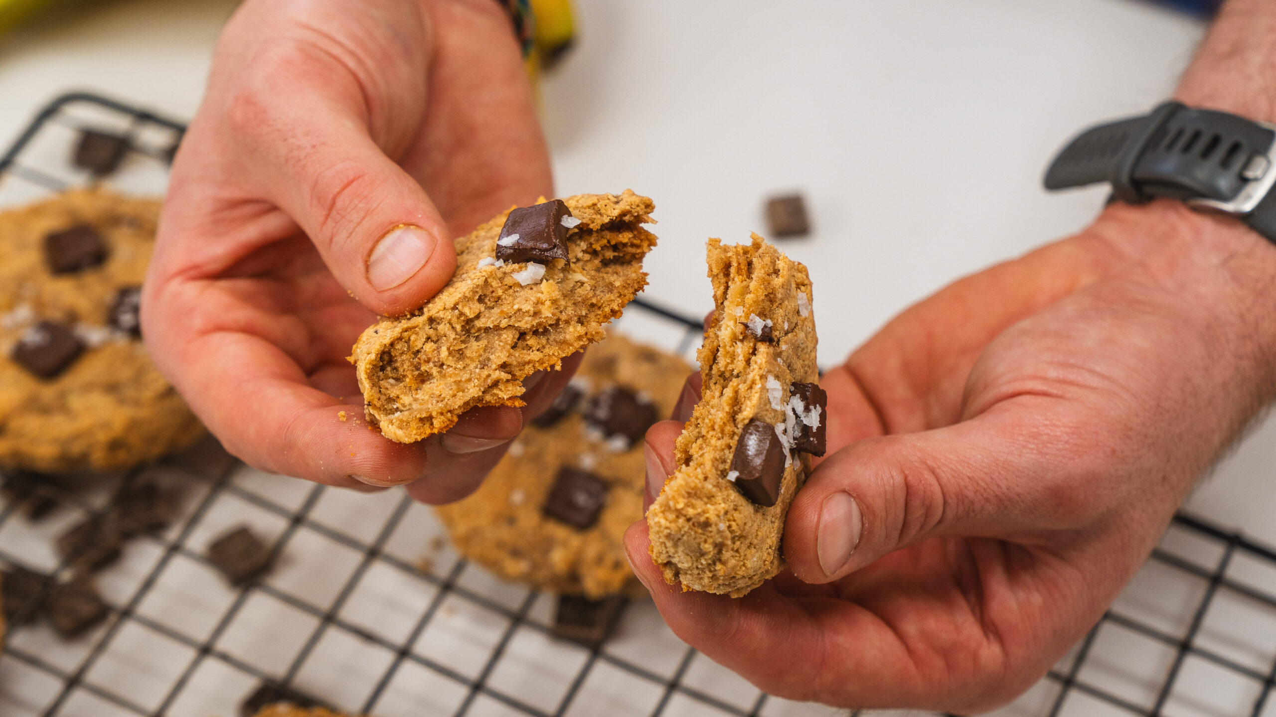 3 ingredient protein chocolate chip cookie being split in half.