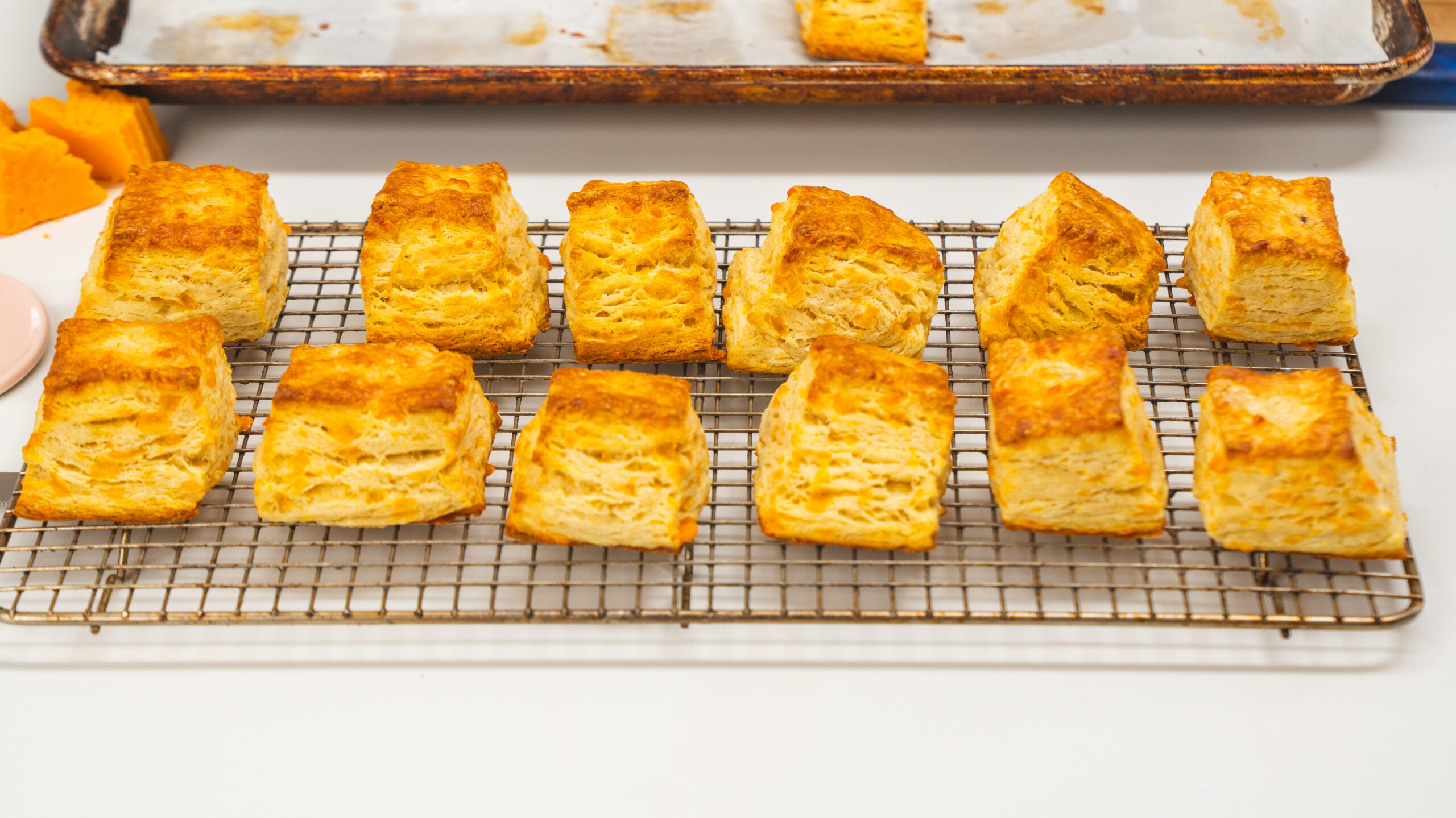 Buttermilk biscuits sitting on a cooling rack.