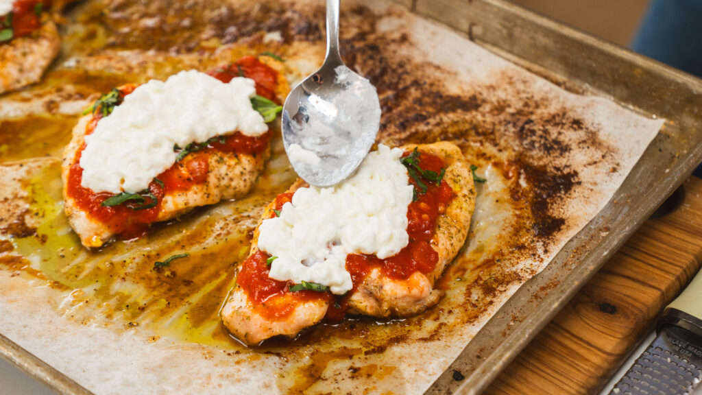 High Protein Chicken Parmesan with a dollop of cottage cheese on top.