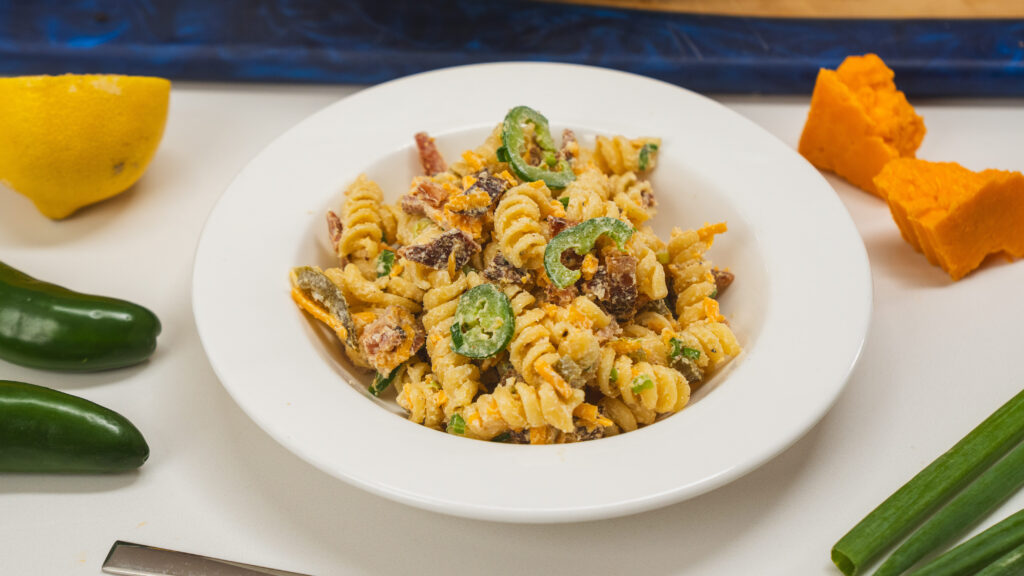 Jalapeno popper pasta salad in a white bowl.