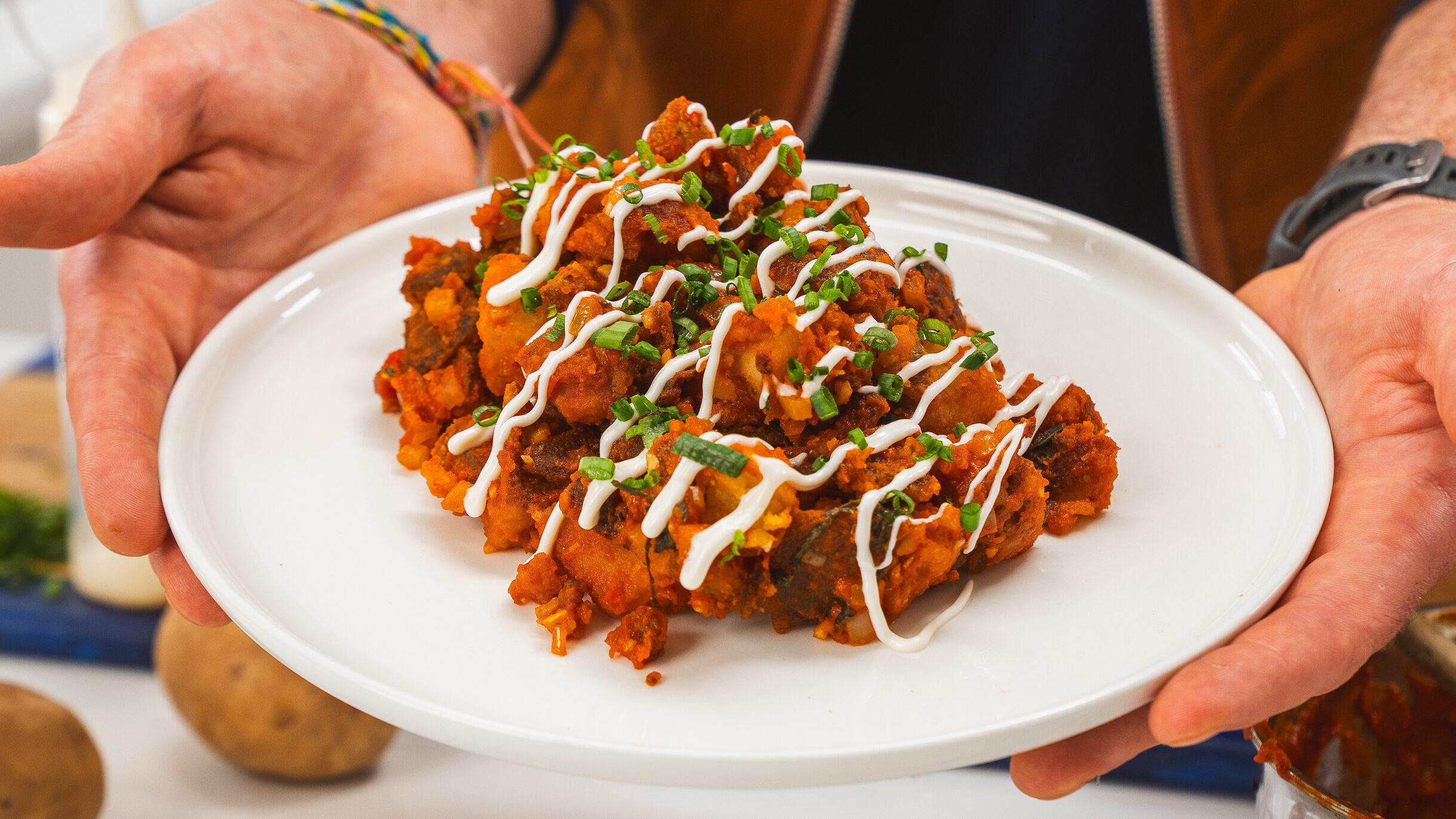 Patatas Bravas recipe on a plate with lemon aioli sauce.