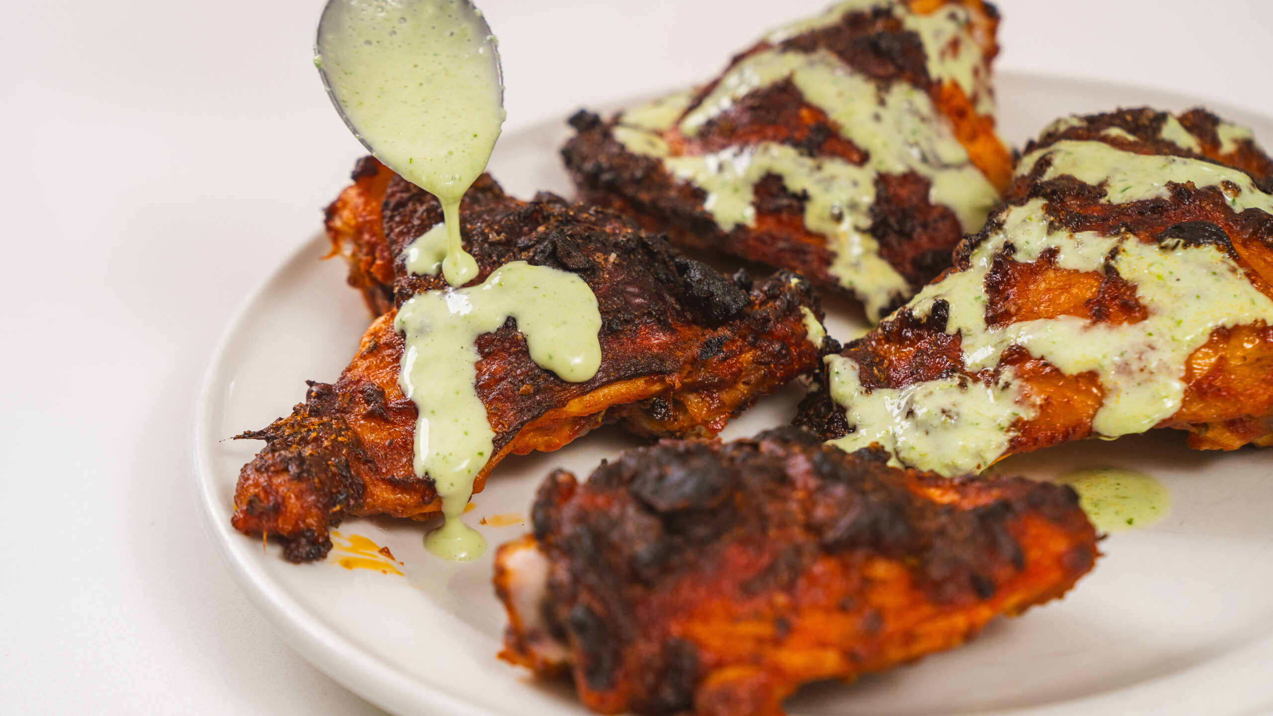 Oven baked chicken thighs with an herb dressing on top.